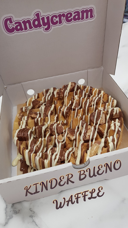 Warm waffle topped with milk chocolate sauce, and white chocolate drizzle from 
Candy Cream dessert shop in Bathgate 